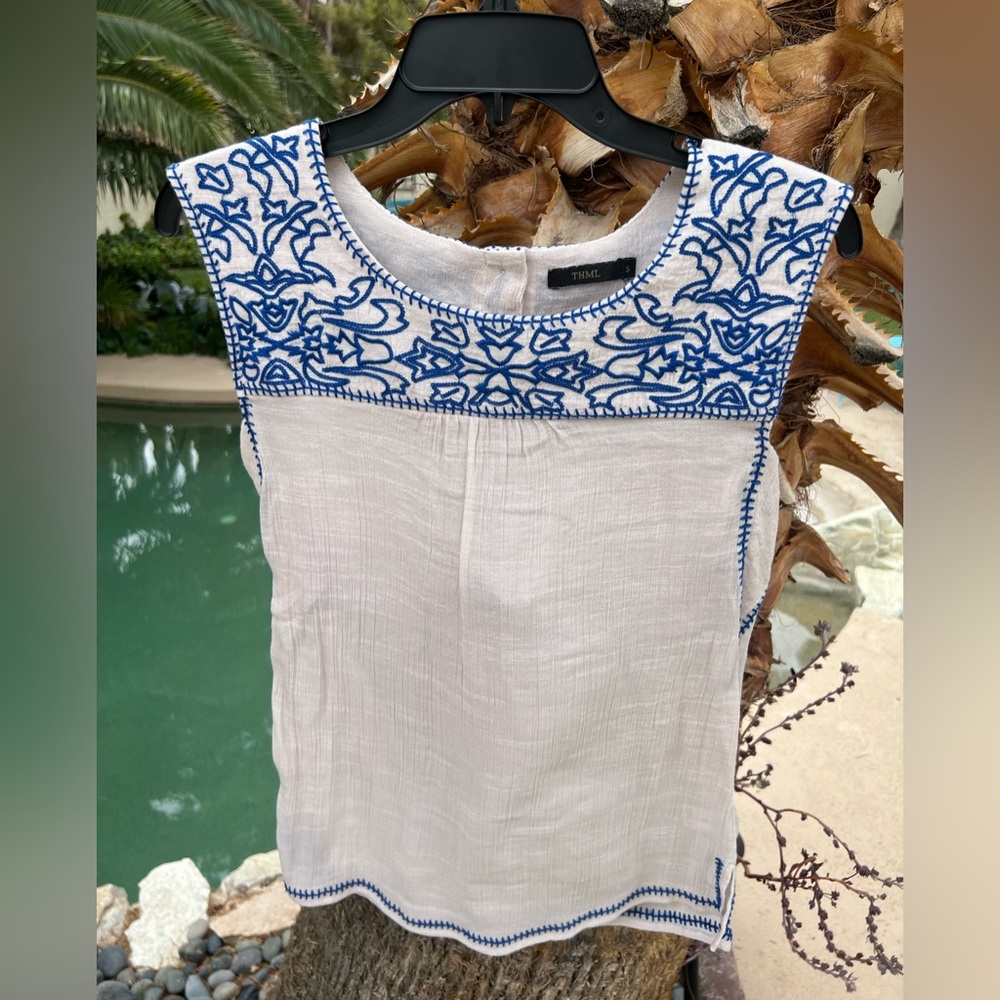 Fancy white and blue top.